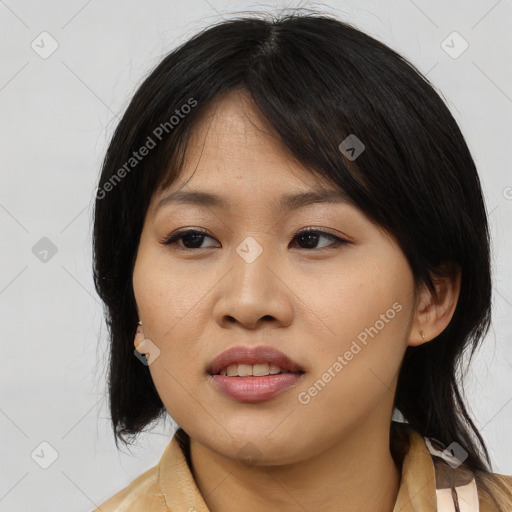 Joyful asian young-adult female with medium  black hair and brown eyes