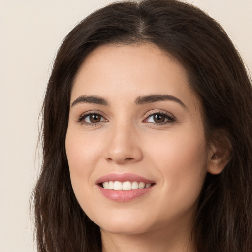 Joyful white young-adult female with long  brown hair and brown eyes