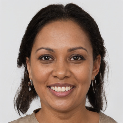 Joyful black adult female with medium  brown hair and brown eyes