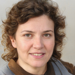 Joyful white young-adult female with medium  brown hair and blue eyes