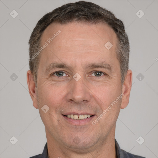 Joyful white adult male with short  brown hair and brown eyes