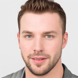 Joyful white young-adult male with short  brown hair and blue eyes