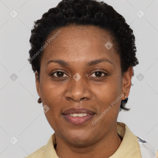 Joyful black adult female with short  black hair and brown eyes