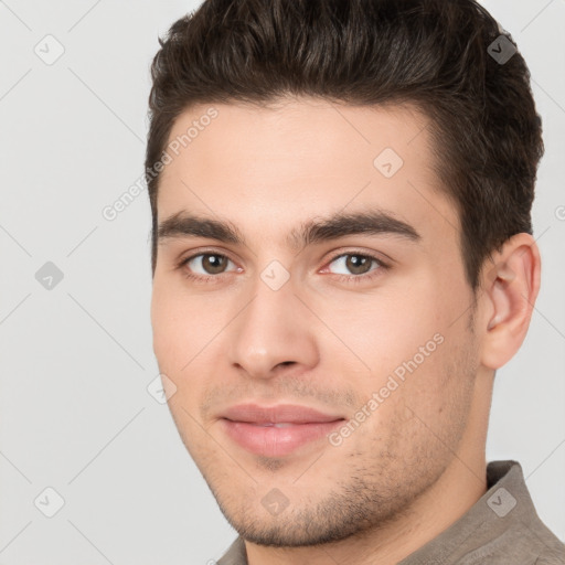 Joyful white young-adult male with short  brown hair and brown eyes