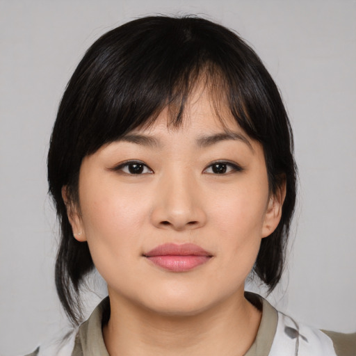 Joyful asian young-adult female with medium  brown hair and brown eyes