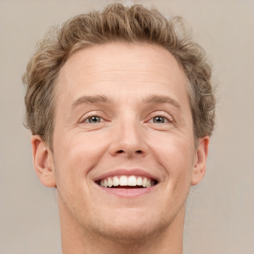 Joyful white adult male with short  brown hair and grey eyes