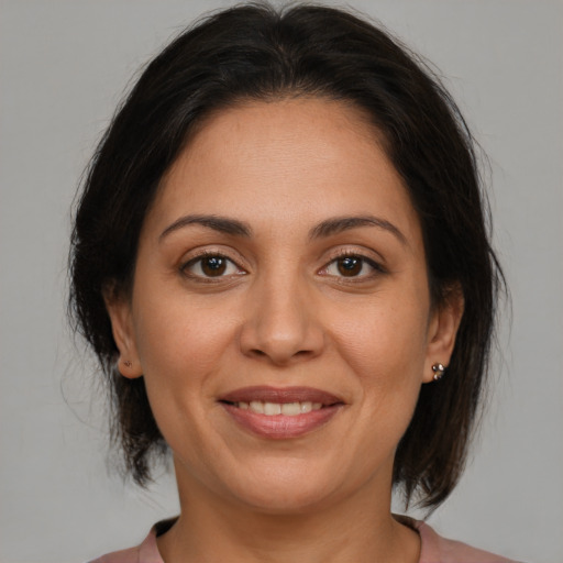 Joyful white adult female with medium  brown hair and brown eyes