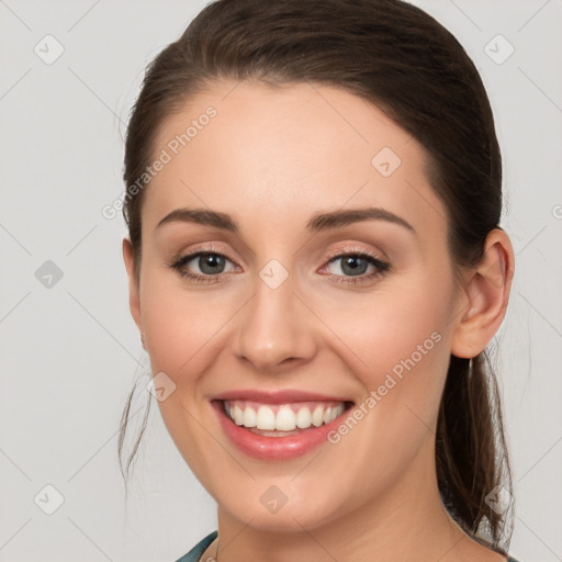 Joyful white young-adult female with long  brown hair and grey eyes