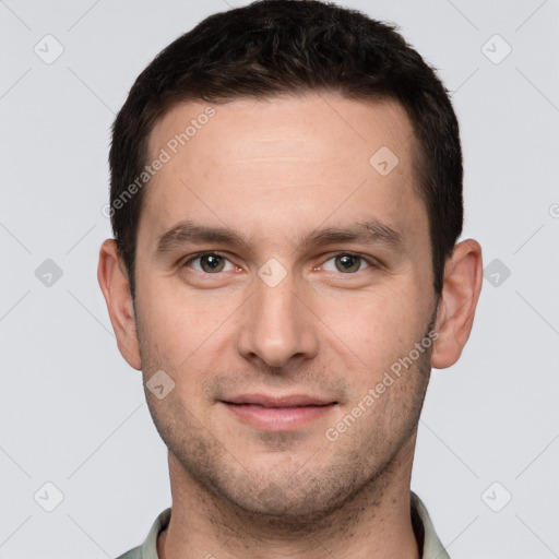 Joyful white young-adult male with short  brown hair and grey eyes