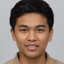 Joyful latino young-adult male with short  brown hair and brown eyes