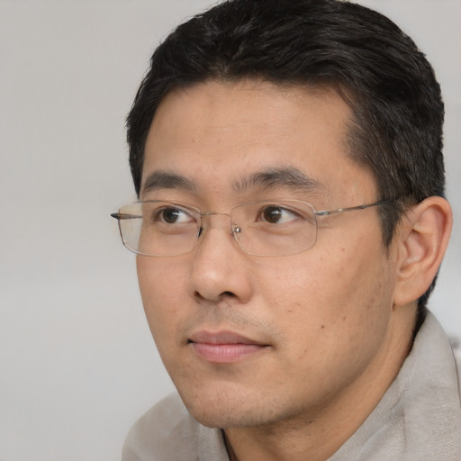 Neutral asian adult male with short  black hair and brown eyes