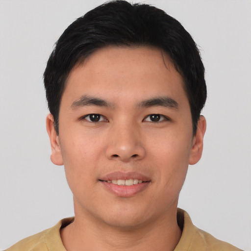 Joyful asian young-adult male with short  black hair and brown eyes