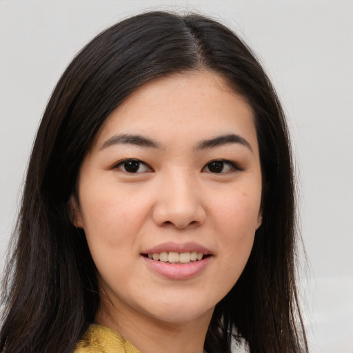 Joyful asian young-adult female with long  brown hair and brown eyes