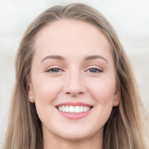 Joyful white young-adult female with long  brown hair and grey eyes