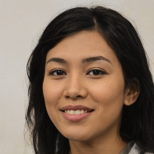 Joyful latino young-adult female with long  black hair and brown eyes