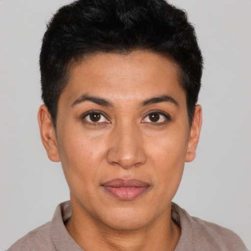 Joyful latino young-adult female with short  black hair and brown eyes