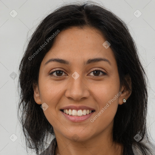 Joyful latino young-adult female with long  brown hair and brown eyes