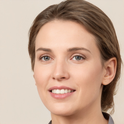 Joyful white young-adult female with medium  brown hair and grey eyes