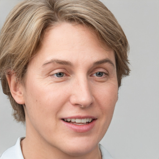 Joyful white adult female with short  brown hair and grey eyes