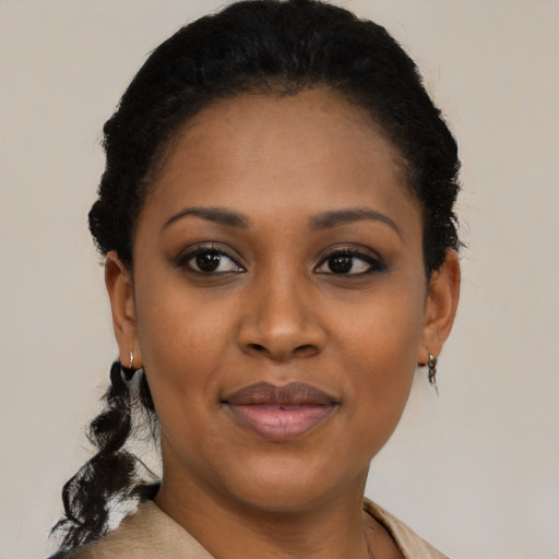 Joyful black young-adult female with short  black hair and brown eyes