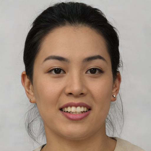 Joyful asian young-adult female with medium  black hair and brown eyes