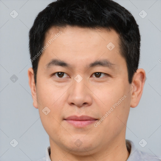 Joyful asian young-adult male with short  brown hair and brown eyes