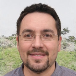 Joyful white adult male with short  brown hair and brown eyes