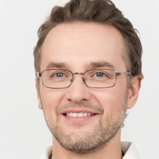 Joyful white adult male with short  brown hair and grey eyes