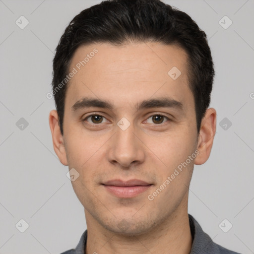 Joyful white young-adult male with short  black hair and brown eyes