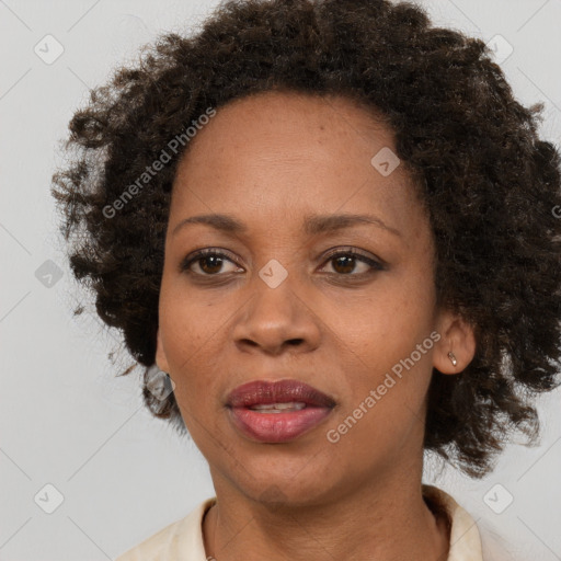 Joyful black adult female with medium  brown hair and brown eyes