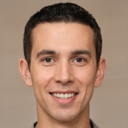 Joyful white adult male with short  brown hair and brown eyes