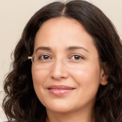 Joyful white adult female with long  brown hair and brown eyes