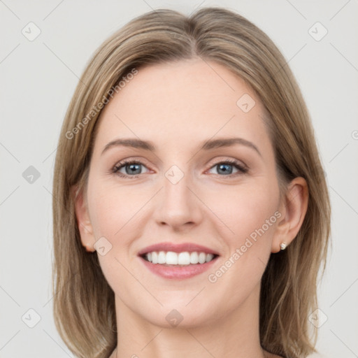 Joyful white young-adult female with long  brown hair and grey eyes