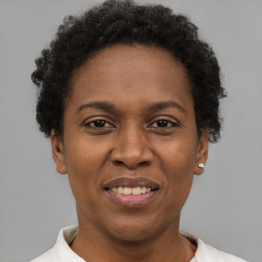 Joyful black adult female with short  brown hair and brown eyes