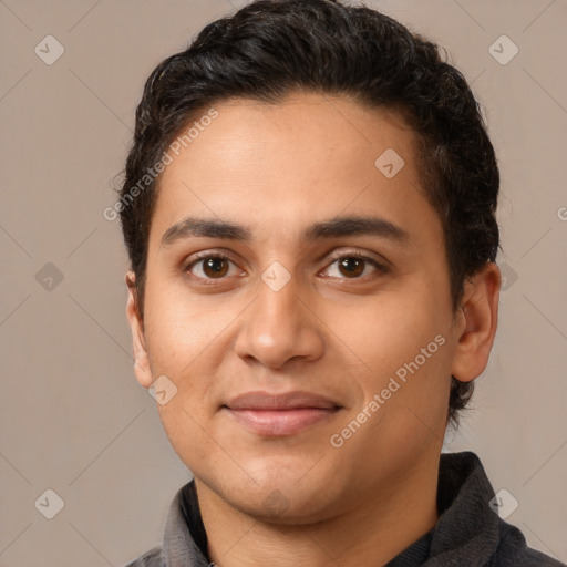 Joyful latino young-adult male with short  brown hair and brown eyes