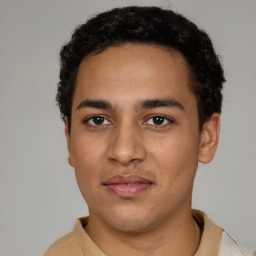 Joyful latino young-adult male with short  brown hair and brown eyes