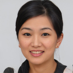 Joyful asian young-adult female with medium  black hair and brown eyes