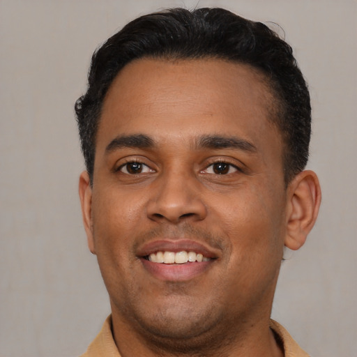 Joyful latino young-adult male with short  brown hair and brown eyes