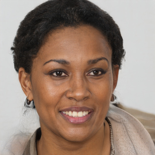Joyful black adult female with short  brown hair and brown eyes