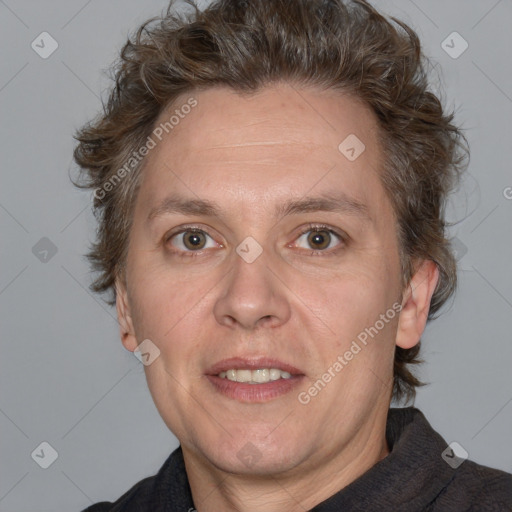 Joyful white adult male with short  brown hair and blue eyes