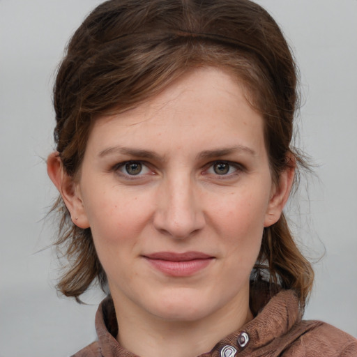 Joyful white young-adult female with medium  brown hair and blue eyes