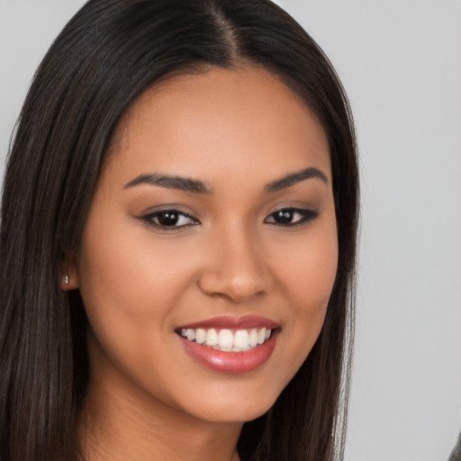 Joyful latino young-adult female with long  brown hair and brown eyes