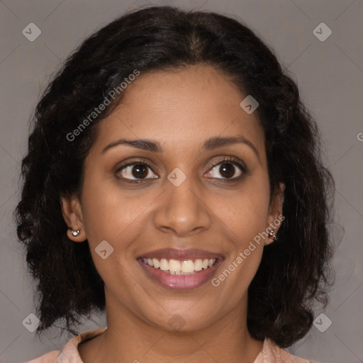 Joyful black young-adult female with long  brown hair and brown eyes