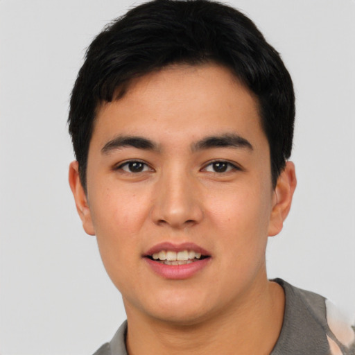Joyful asian young-adult male with short  black hair and brown eyes