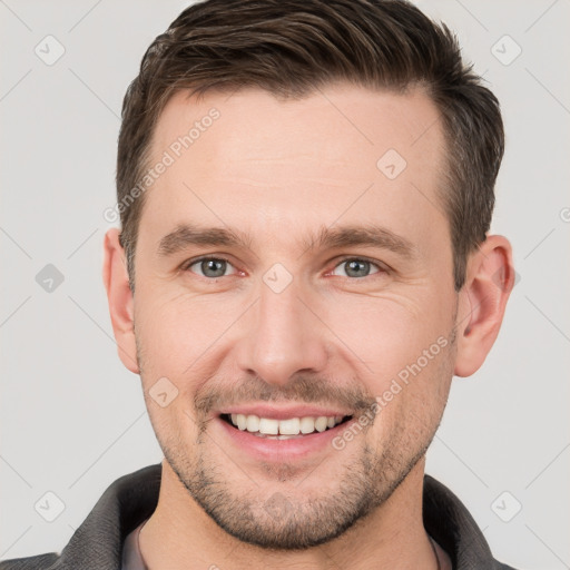 Joyful white young-adult male with short  brown hair and brown eyes