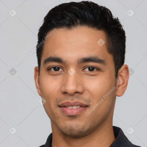 Joyful latino young-adult male with short  black hair and brown eyes