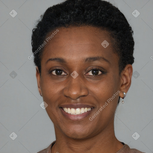 Joyful black young-adult female with short  black hair and brown eyes