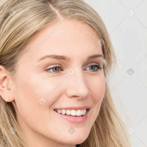 Joyful white young-adult female with long  brown hair and blue eyes