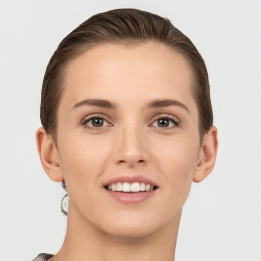 Joyful white young-adult female with short  brown hair and brown eyes