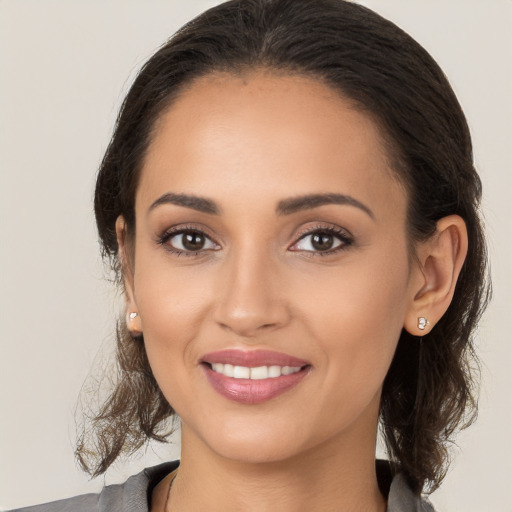 Joyful white young-adult female with long  brown hair and brown eyes